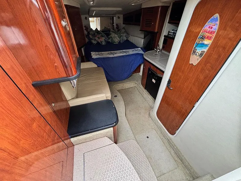 Slide: The Image of Interior of 2006 Sea Ray 290 Sundancer with cozy cabin and wooden finishes. - 17