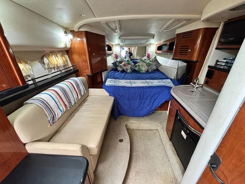 Slide: The Image of Interior of 2006 Sea Ray 290 Sundancer with cozy seating and bed. - 19
