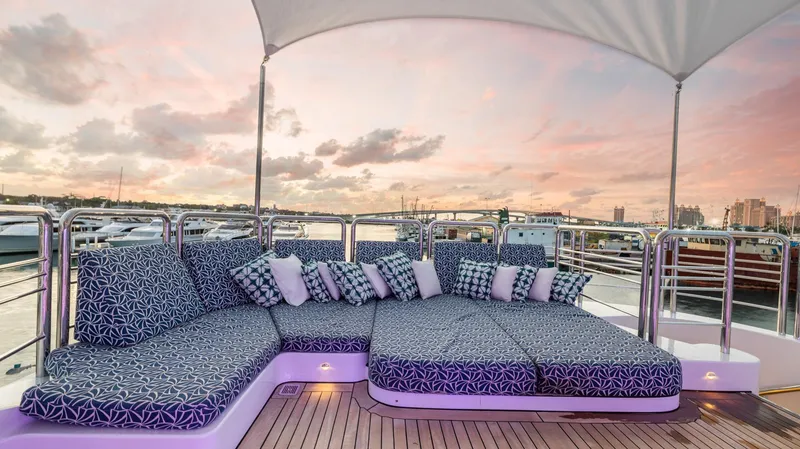 Slide: The Image of Luxurious 2005 New Zealand Yachts Wave Piercer deck with patterned cushions at sunset. - 13