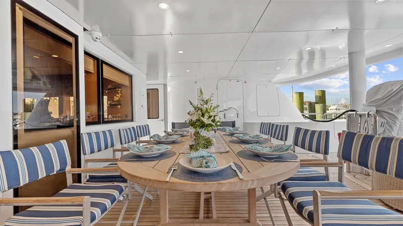 Slide: The Image of Luxurious 2005 New Zealand Yachts Wave Piercer dining area with elegant table setting and striped chairs. - 20