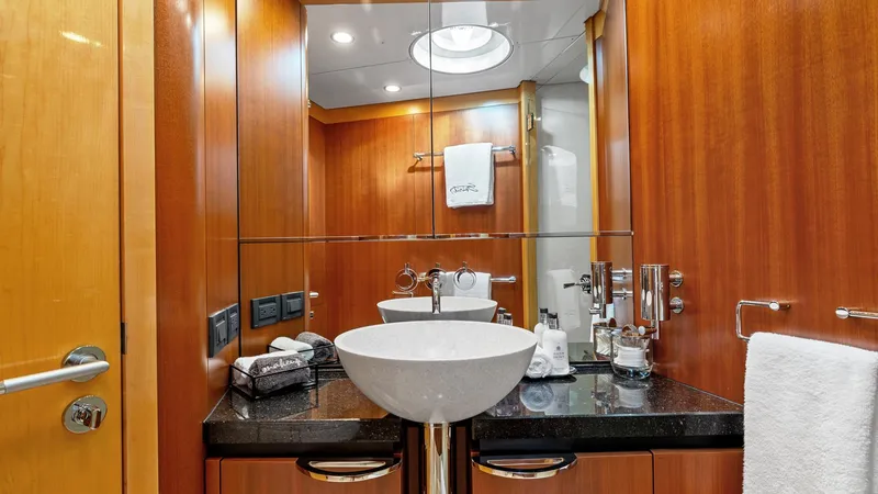 Slide: The Image of Luxurious yacht bathroom with modern sink, wooden cabinetry, and mirrored walls on 2005 New Zealand Yachts Wave Piercer. - 44