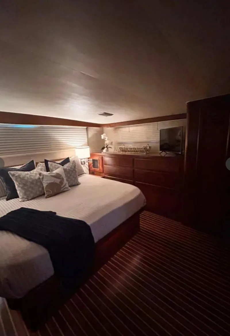 Slide: The Image of Luxurious bedroom in 1989 Hatteras 67 Cockpit Motor Yacht with elegant decor. - 21