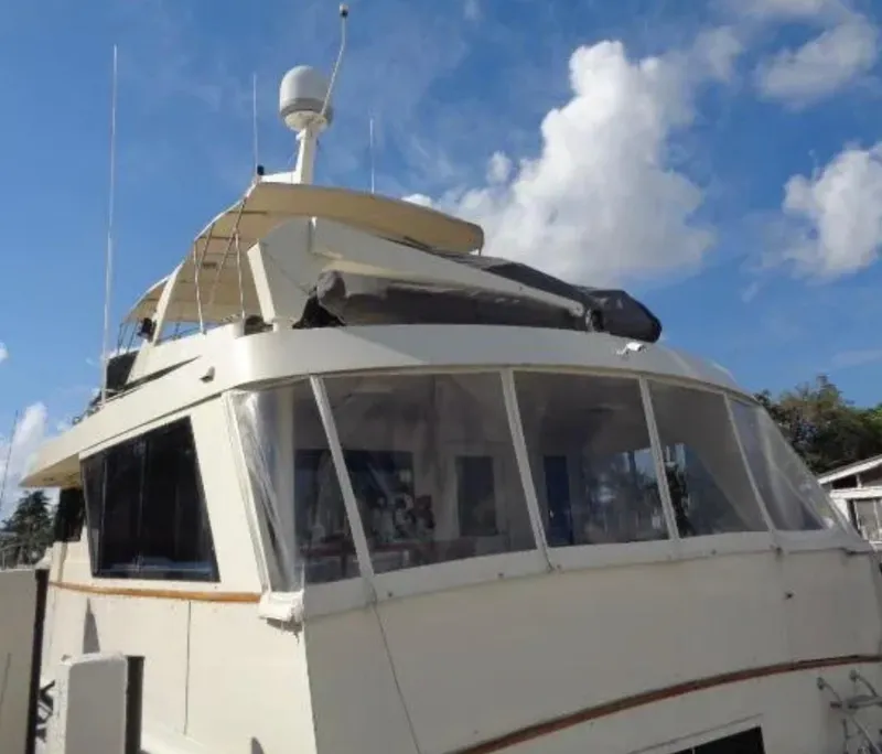 Slide: The Image of 1989 Hatteras 67 Cockpit Motor Yacht under a clear blue sky. - 3