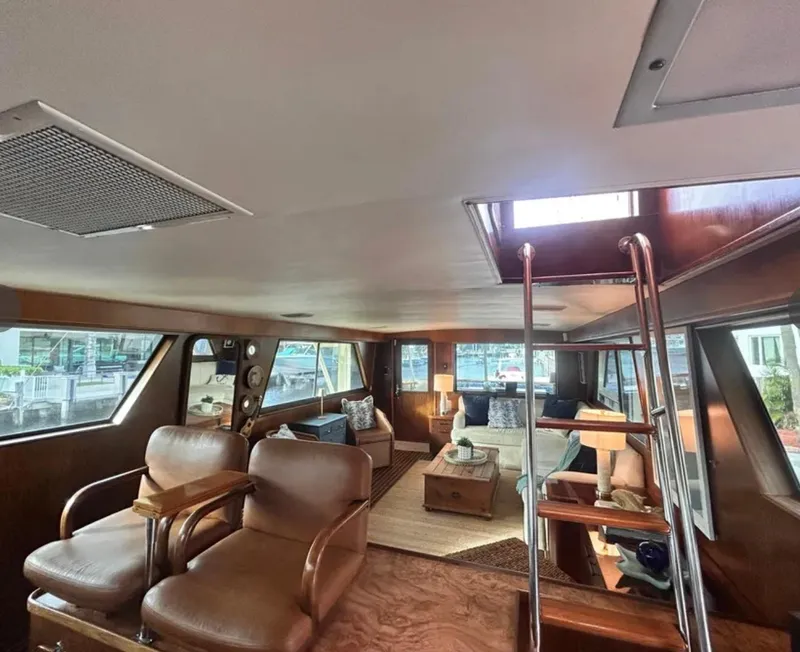 Slide: The Image of Interior of 1989 Hatteras 67 Cockpit Motor Yacht with elegant seating and wooden accents. - 24