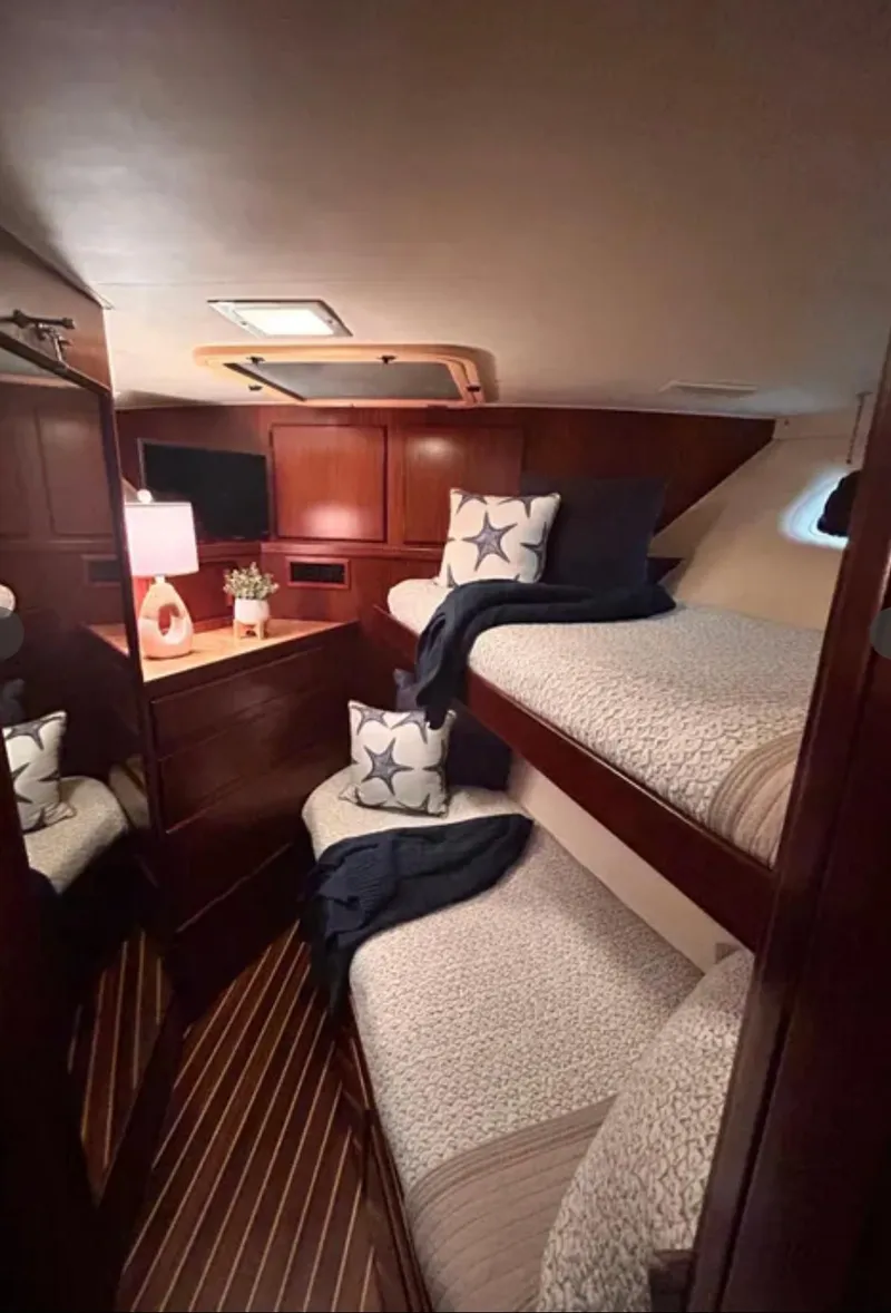 Slide: The Image of Interior of 1989 Hatteras 67 Cockpit Motor Yacht with cozy bunk beds and nautical decor. - 15