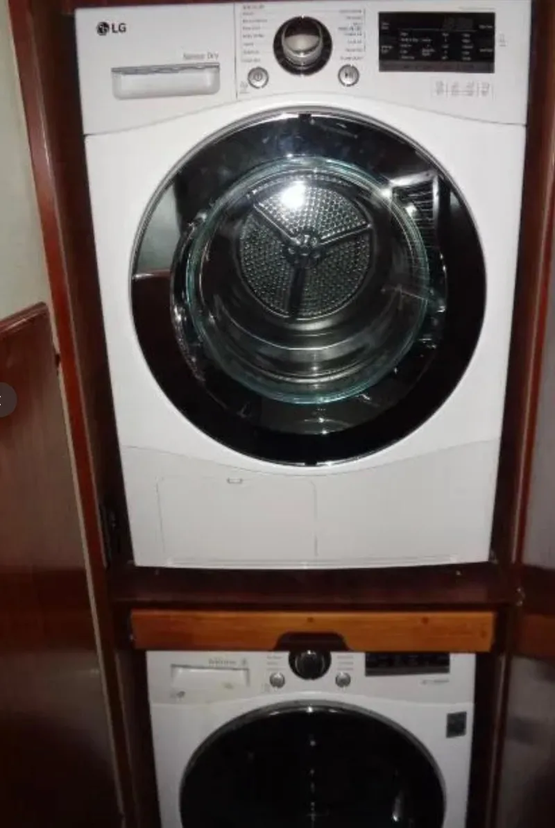 Slide: The Image of Stacked LG washer and dryer inside 1989 Hatteras 67 Cockpit Motor Yacht. - 28