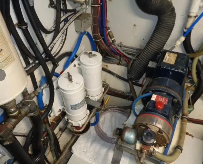 Slide: The Image of Engine room of 1989 Hatteras 67 Cockpit Motor Yacht with filters and machinery. - 31