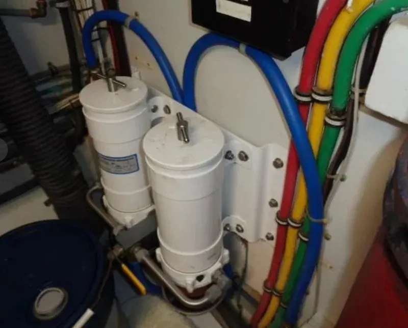 Slide: The Image of Engine room of 1989 Hatteras 67 Cockpit Motor Yacht with filters and colorful wiring. - 35