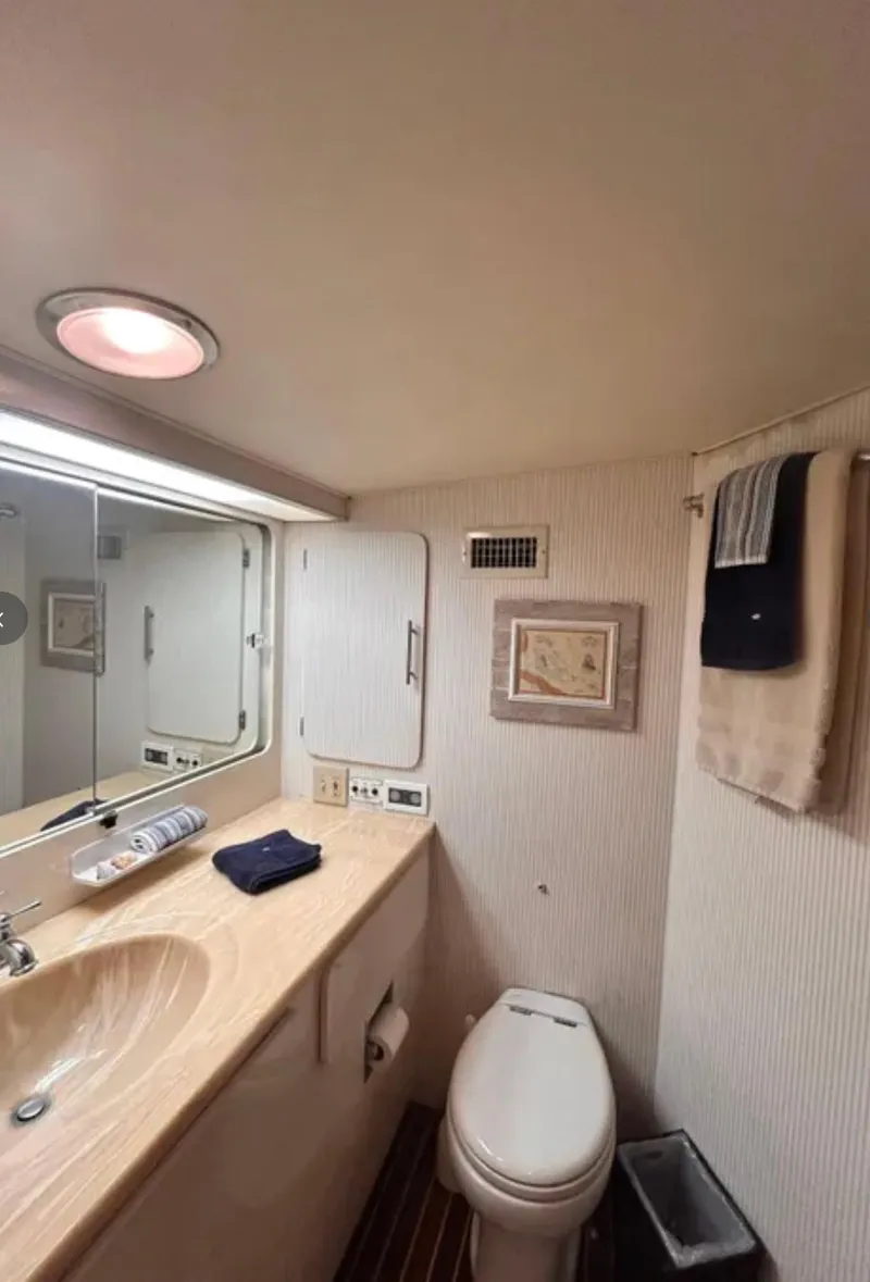 Slide: The Image of Bathroom interior of 1989 Hatteras 67 Cockpit Motor Yacht, featuring sink and toilet. - 20