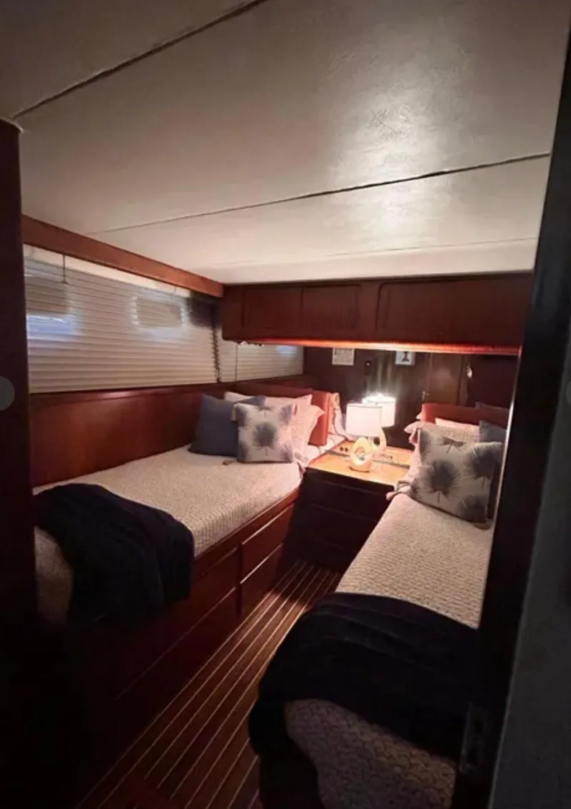 Slide: The Image of Interior of 1989 Hatteras 67 Cockpit Motor Yacht with twin beds and cozy decor. - 18