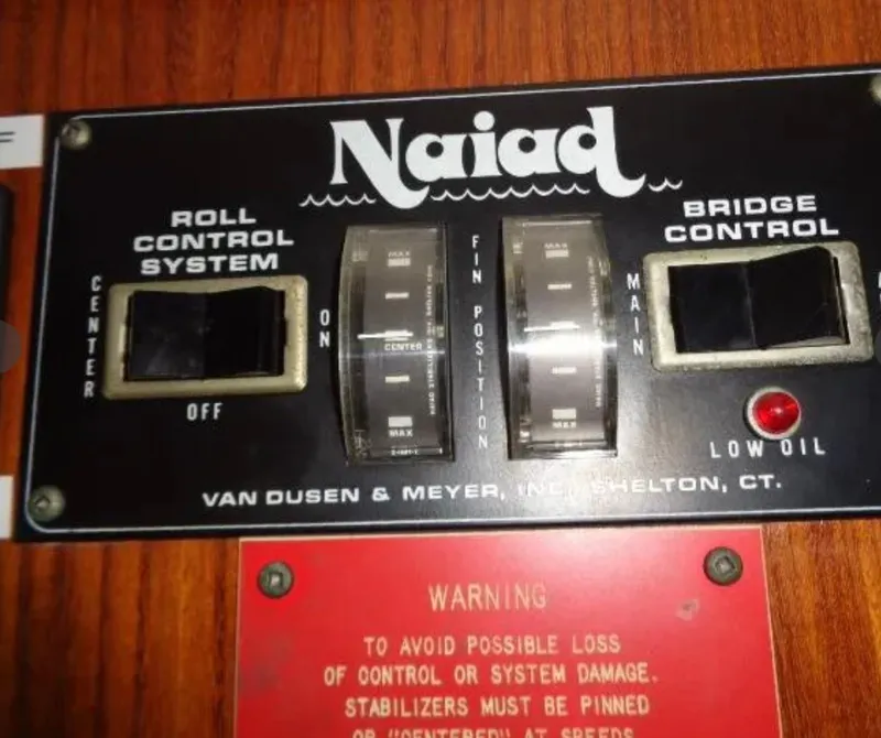 Slide: The Image of Control panel of 1989 Hatteras 67 Cockpit Motor Yacht, featuring Naiad roll and bridge control systems. - 5