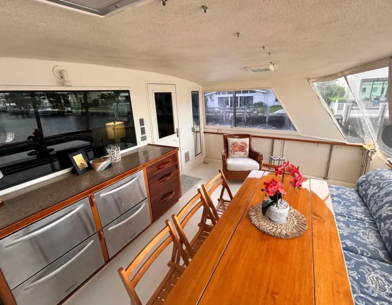 Slide: The Image of Luxurious interior of 1989 Hatteras 67 Cockpit Motor Yacht with elegant dining area. - 11