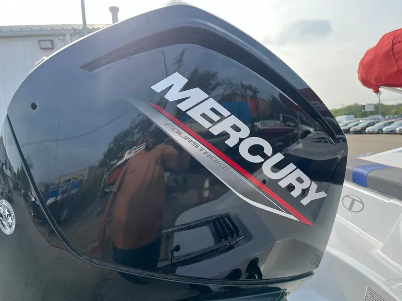 Slide: The Image of Mercury outboard motor on 2022 Tahoe T16 boat, reflecting outdoor scene. - 14