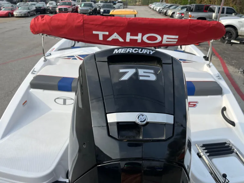 Slide: The Image of 2022 Tahoe T16 boat with Mercury 75 engine, parked in a lot. - 15