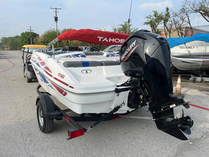 Slide: The Image of 2022 Tahoe T16 boat with Mercury engine on trailer, featuring red and blue accents. - 16