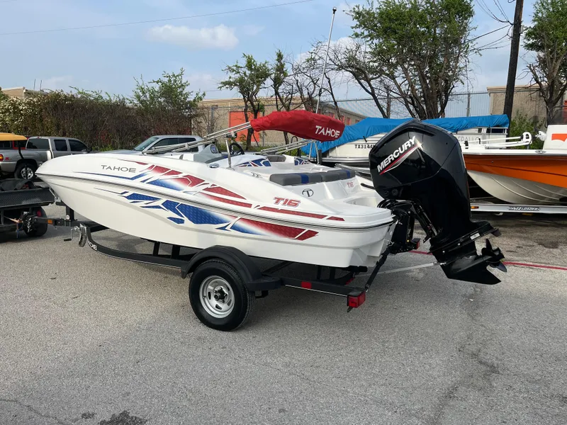 Slide: The Image of 2022 Tahoe T16 boat with Mercury engine on trailer, featuring red and blue graphics. - 17