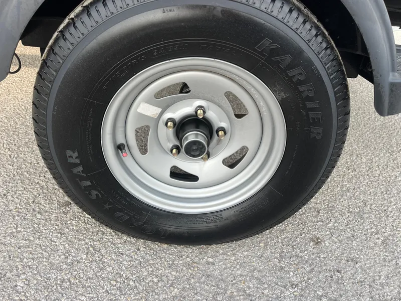 Slide: The Image of 2022 Tahoe T16 wheel with Karrier tire on asphalt surface. - 21