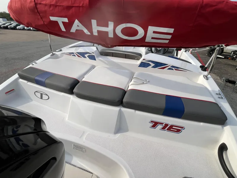 Slide: The Image of 2022 Tahoe T16 boat with cushioned seating and red canopy. - 24