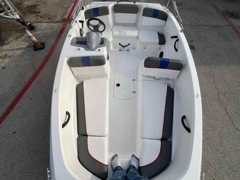 Slide: The Image of 2022 Tahoe T16 boat interior with seating and steering wheel, viewed from above. - 26