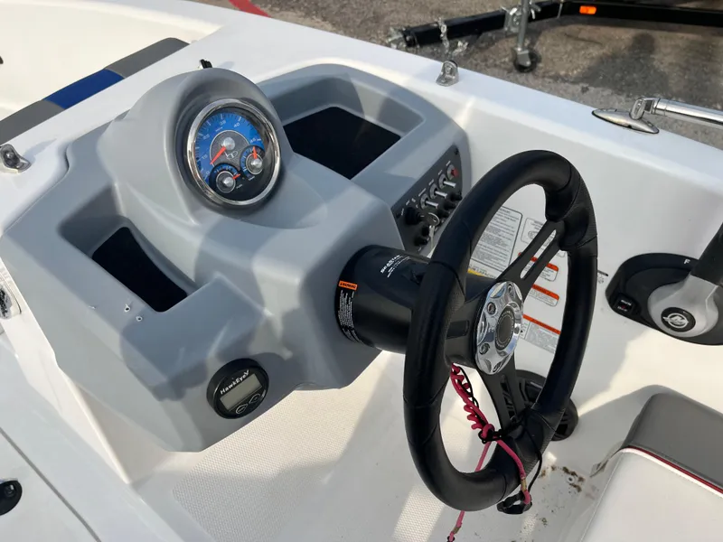 Slide: The Image of 2022 Tahoe T16 boat dashboard with steering wheel and gauges. - 31