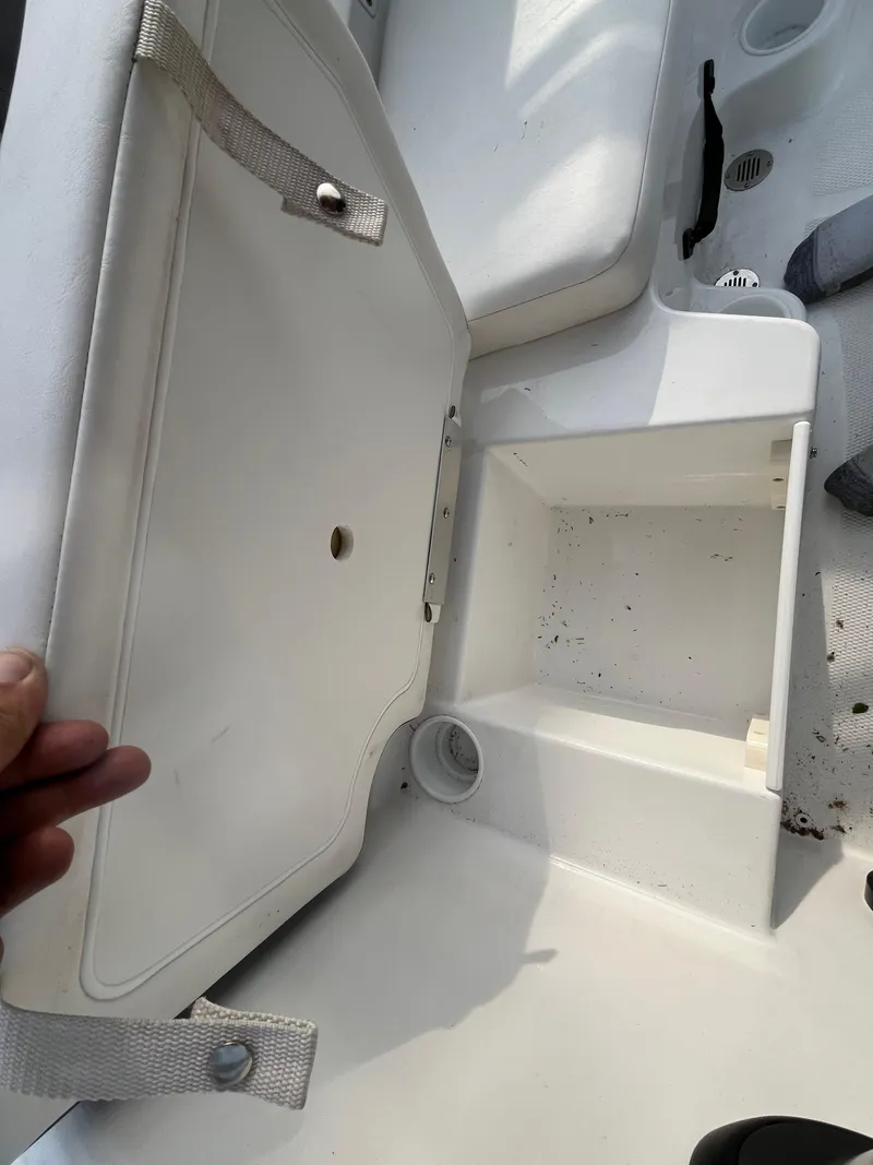 Slide: The Image of 2022 Tahoe T16 boat storage compartment with open lid, showing interior space. - 33