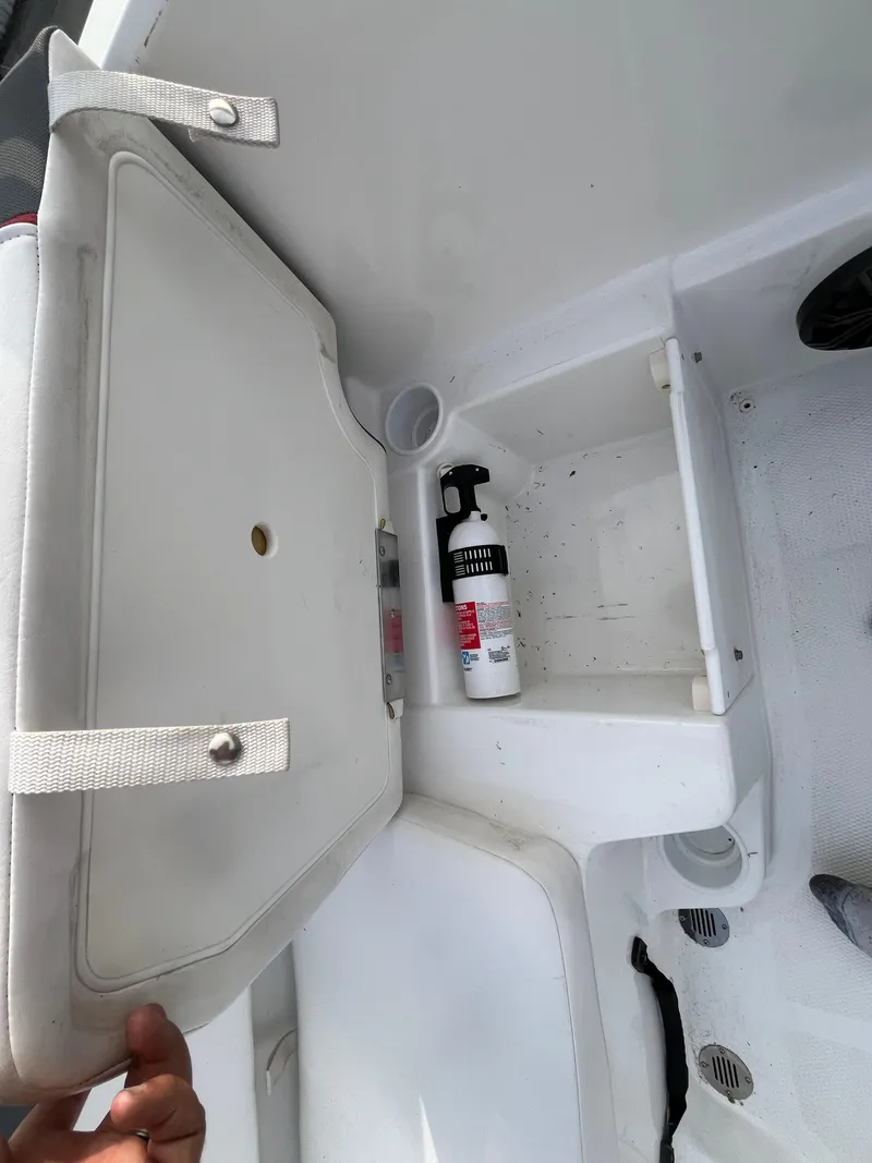 Slide: The Image of 2022 Tahoe T16 boat storage compartment with cleaning spray bottle. - 35