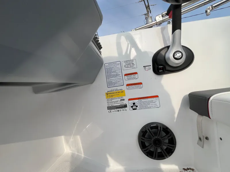 Slide: The Image of Control panel of 2022 Tahoe T16 boat with warning labels and speaker. - 36
