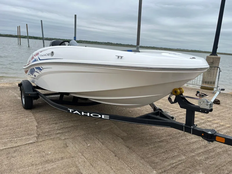 Slide: The Image of 2022 Tahoe T16 boat on trailer by the water, overcast sky. - 39