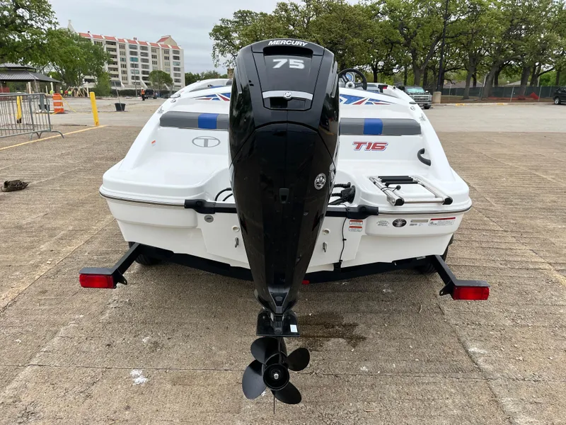 Slide: The Image of 2022 Tahoe T16 boat with Mercury 75 outboard motor, parked on a trailer. - 44