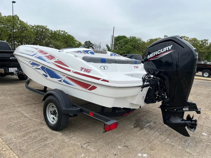 Slide: The Image of 2022 Tahoe T16 boat with Mercury engine on trailer, featuring red and blue graphics. - 45