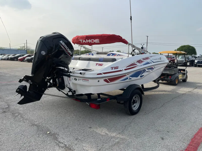 Slide: The Image of 2022 Tahoe T16 boat with Mercury engine on trailer in parking lot. - 9