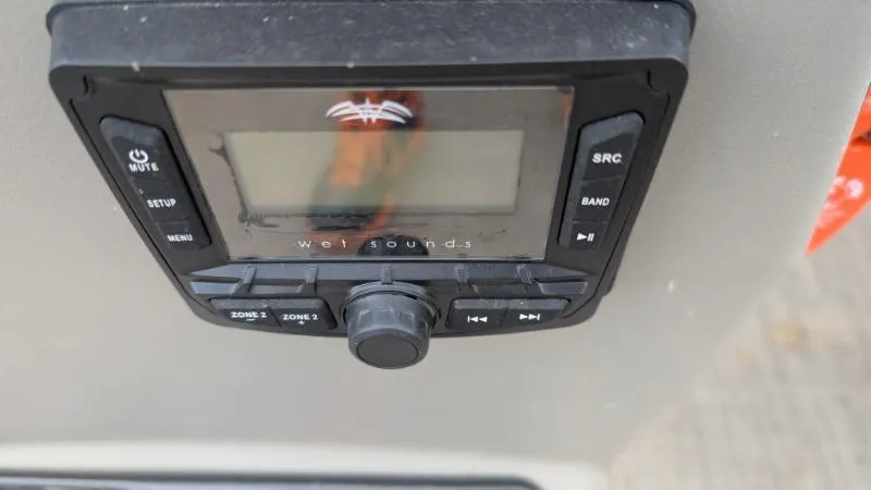 Slide: The Image of 2024 Sun Tracker Bass Buggy 18 DLX audio control panel with buttons and display. - 10