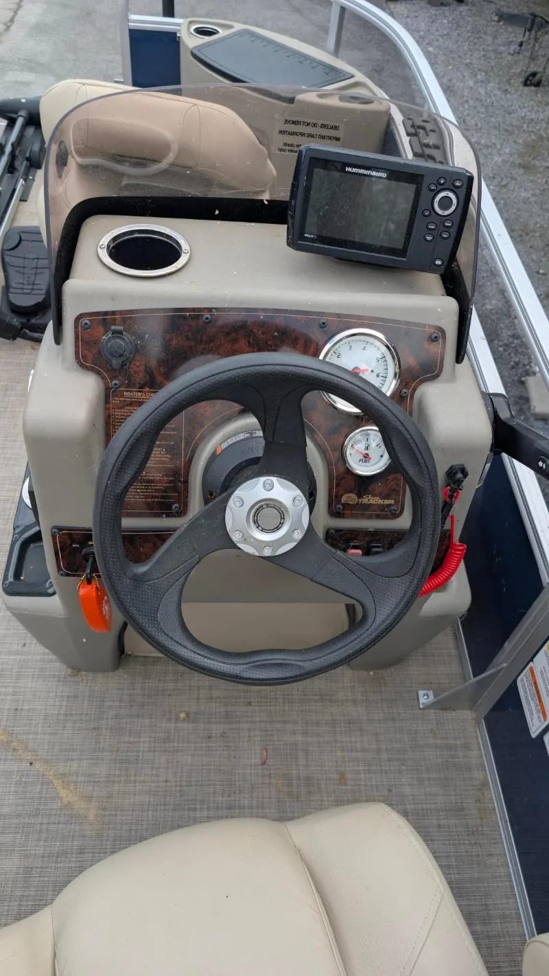 Slide: The Image of 2024 Sun Tracker Bass Buggy 18 DLX steering console with gauges and fish finder. - 6