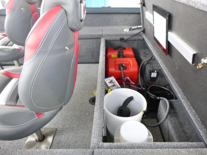 Slide: The Image of 2024 Ranger VS1665SC boat interior with storage compartment, red and gray seats, and equipment. - 10