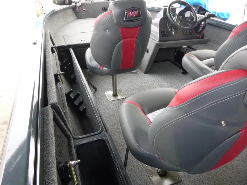 Slide: The Image of 2024 Ranger VS1665SC boat interior with gray and red seating, steering console, and storage compartments. - 5
