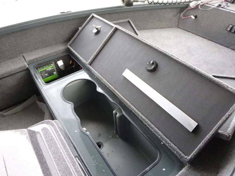 Slide: The Image of 2024 Ranger VS1665SC boat interior with storage compartments and electronic panel. - 7