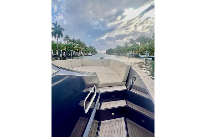 Slide: The Image of 2022 Tesoro T40 Inboard yacht on a scenic waterway with palm trees and cloudy sky. - 10