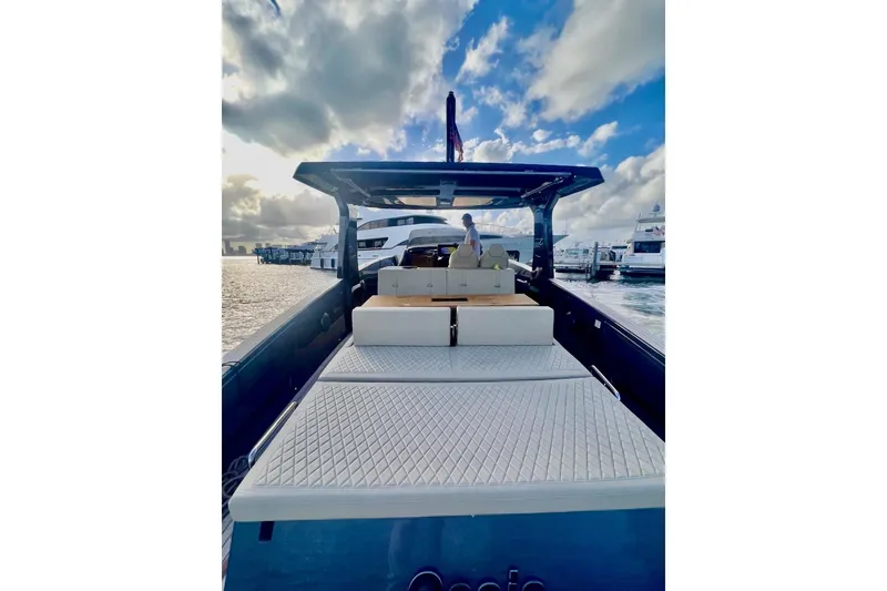 Slide: The Image of 2022 Tesoro T40 Inboard yacht with spacious deck, docked under a cloudy sky. - 12