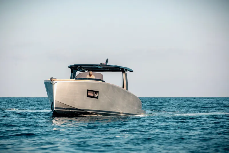 Slide: The Image of 2022 Tesoro T40 Inboard boat cruising on open sea under clear sky. - 2