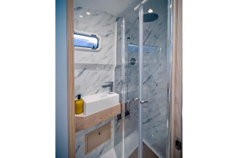 Slide: The Image of Luxurious bathroom in 2022 Tesoro T40 Inboard yacht with marble walls and modern fixtures. - 38