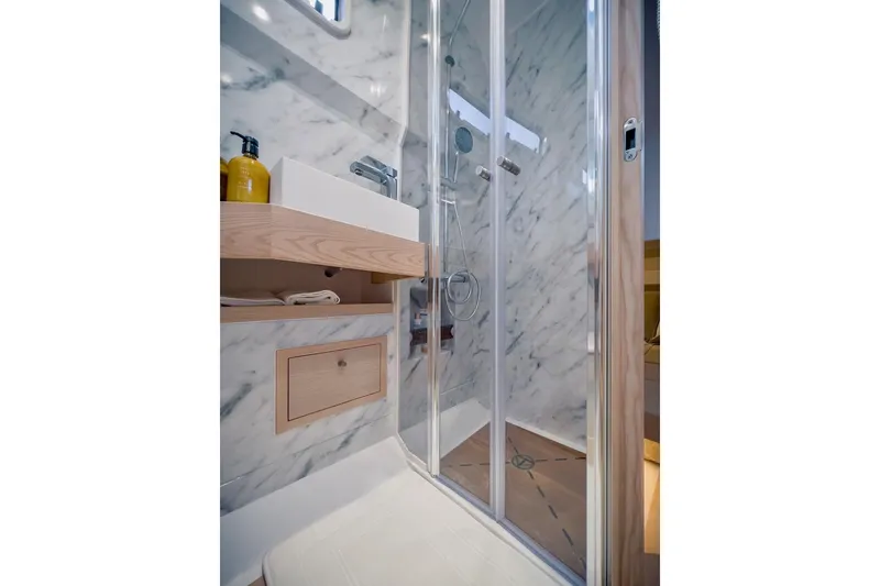 Slide: The Image of Luxurious bathroom in 2022 Tesoro T40 Inboard yacht with marble walls and modern shower. - 39