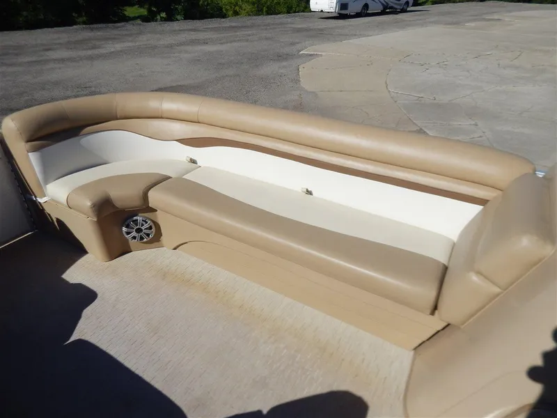 Slide: The Image of 2016 Bennington 24 SSLX boat interior with beige seating and speaker. - 10