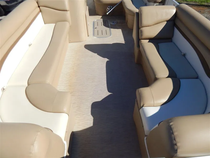 Slide: The Image of 2016 Bennington 24 SSLX boat interior with beige seating and spacious layout. - 11