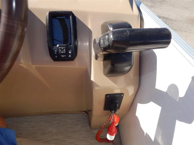 Slide: The Image of 2016 Bennington 24 SSLX boat dashboard with Garmin device and throttle control. - 14