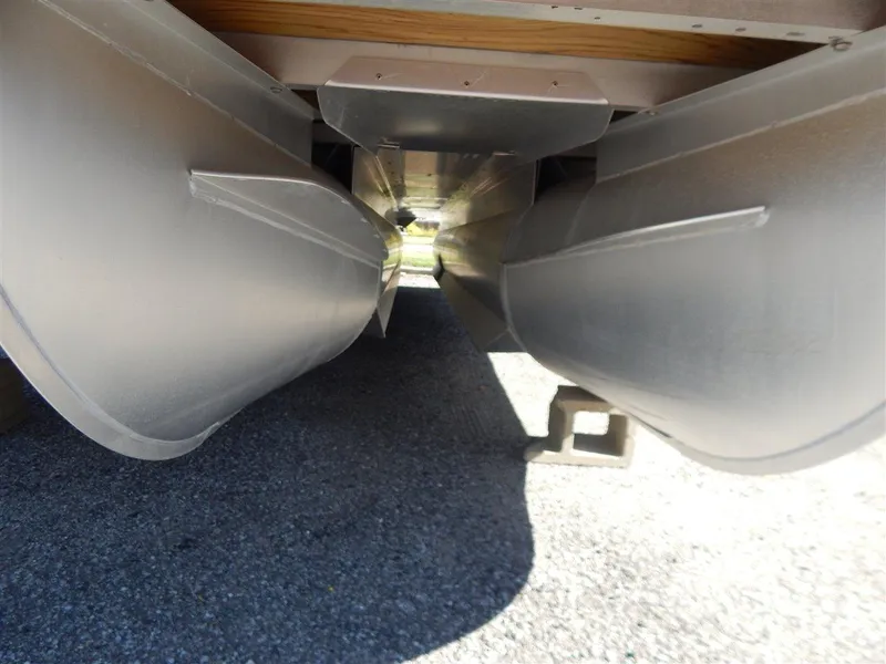 Slide: The Image of Underneath view of a 2016 Bennington 24 SSLX pontoon boat, showcasing dual pontoons. - 15