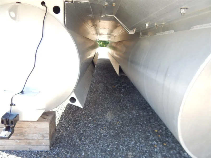 Slide: The Image of Underneath view of a 2016 Bennington 24 SSLX pontoon boat on gravel. - 16