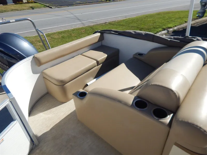 Slide: The Image of 2016 Bennington 24 SSLX pontoon boat interior with beige seating and cup holders. - 6