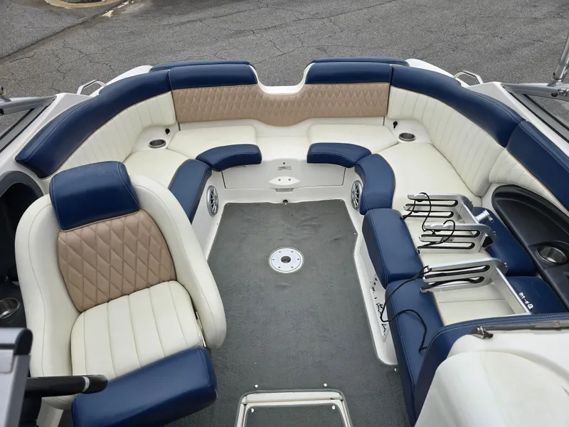 Slide: The Image of 2009 Yamaha Boats AR230 HO interior with blue and beige seating, spacious layout. - 10