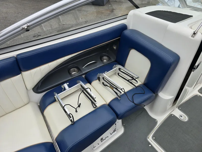 Slide: The Image of 2009 Yamaha Boats AR230 HO interior with blue and white seating and cup holders. - 12