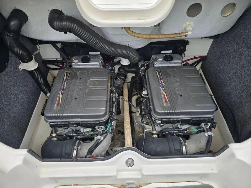 Slide: The Image of 2009 Yamaha Boats AR230 HO engine compartment with dual engines and hoses. - 14